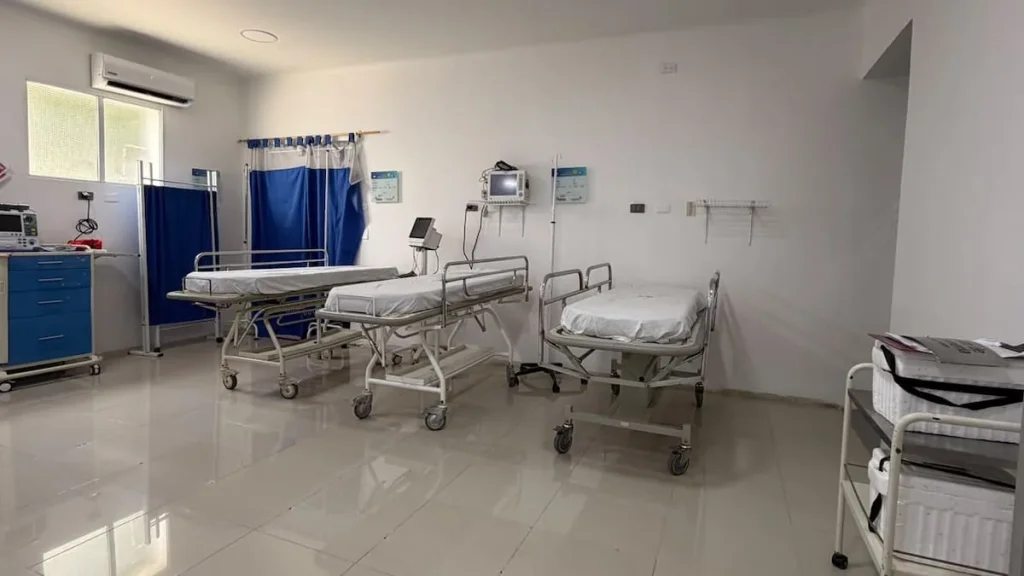 Sala del Hospital de Puerto Berrío con camillas, monitores y cortinas divisorias.